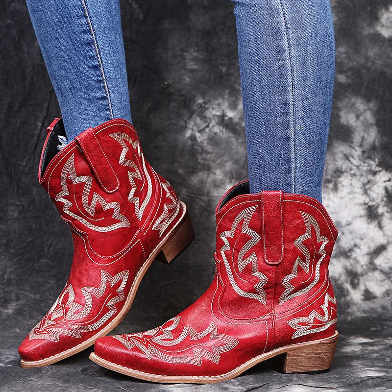 Women's blue embroidered cowboy ankle boots with a low wedge heel and pointed toe.