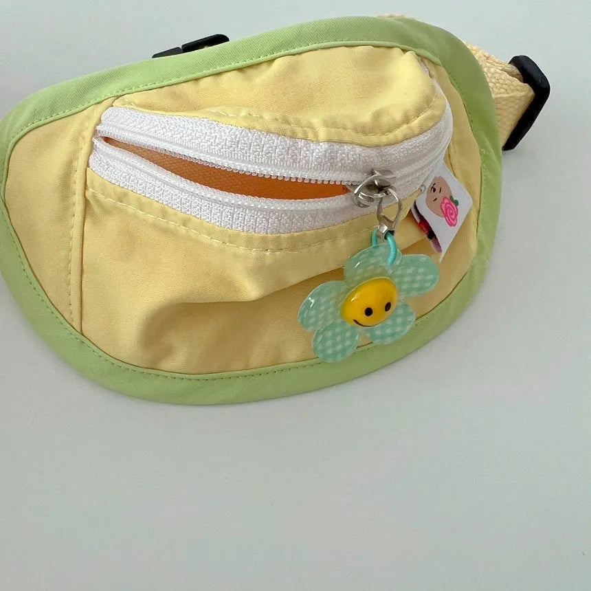 Pink and yellow messenger bag-style pet backpack carrier for small dogs and cats showing adjustable straps