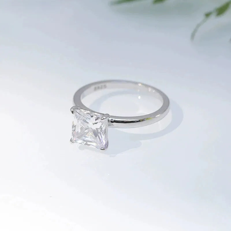 A simple geometric 925 sterling silver ring for women, shown in silver, gold, and rose gold colour options on a grey background.