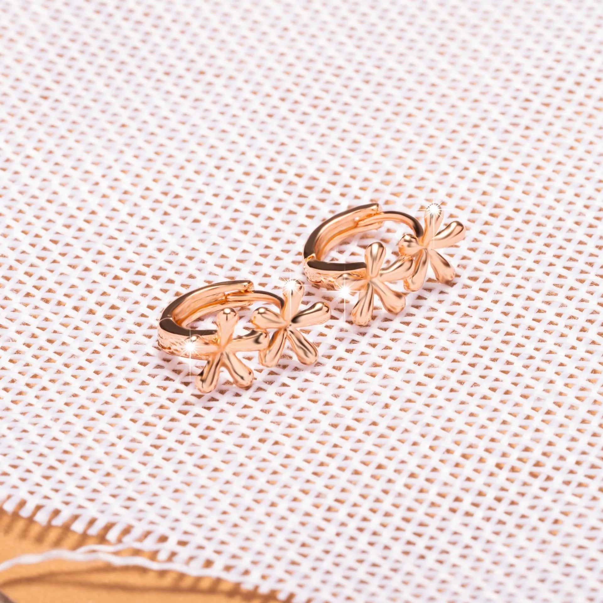 Rose gold circular earrings with a waterdrop flower design for women.