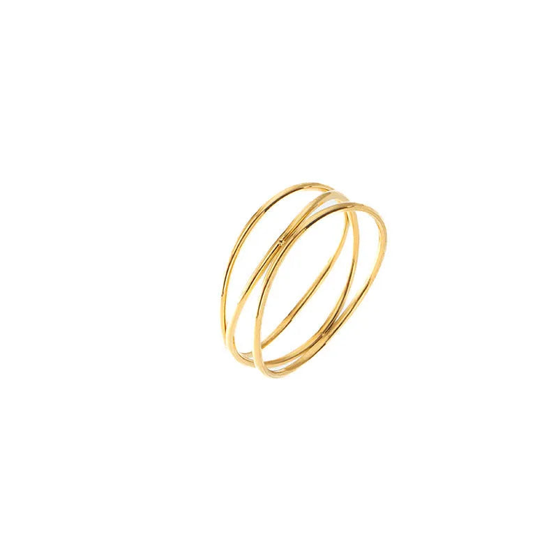 Gold-coloured titanium steel ring with a geometric three-layer coiled design on a hand.