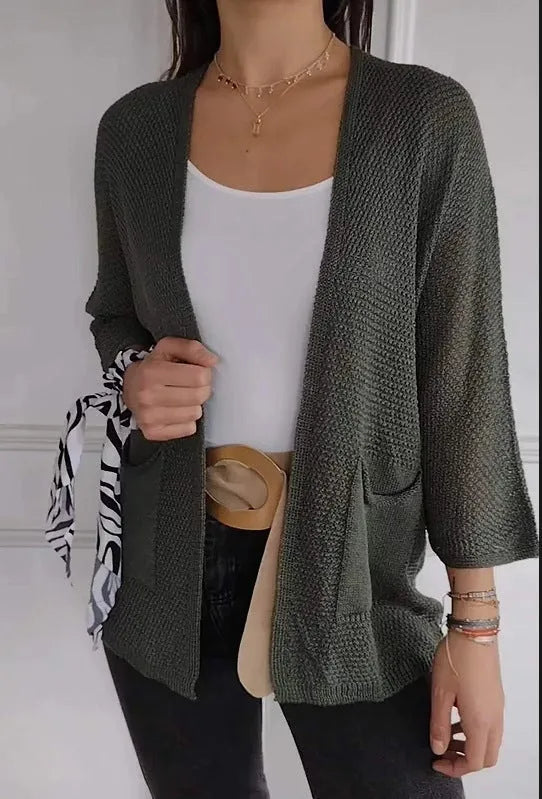Women's army green waffle knit cardigan coat with nine-quarter sleeves and pockets.