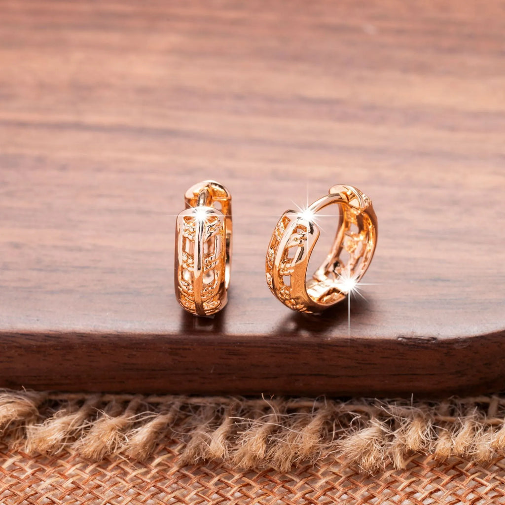 Rose gold hollowed copper earrings in leaf and heart shapes on a white background