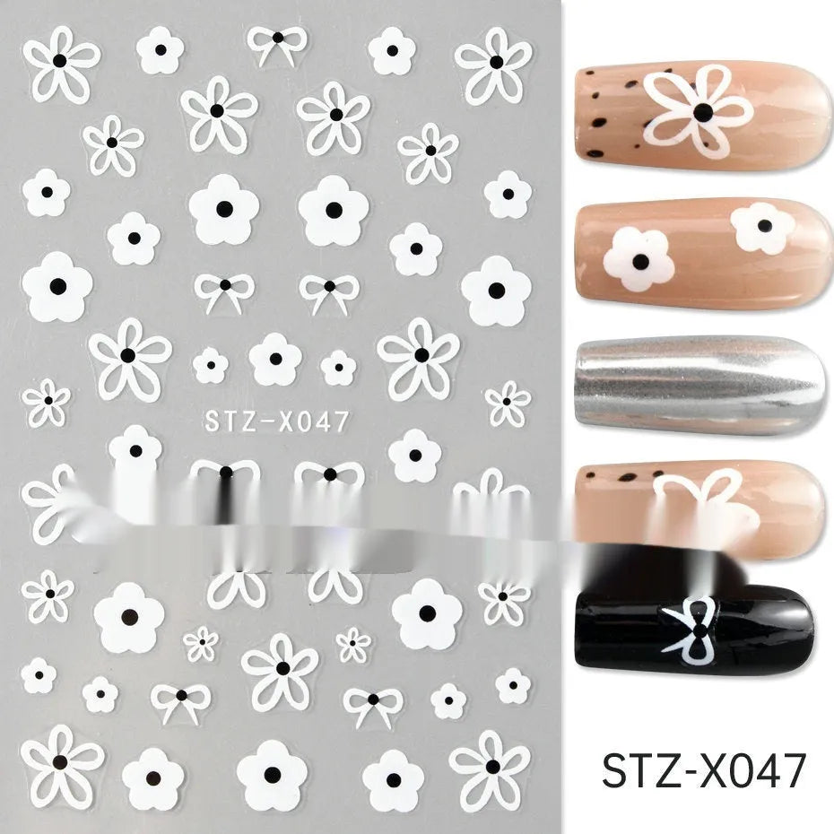 Pack of black and silver striped nail art stickers with cartoon and love pattern designs.