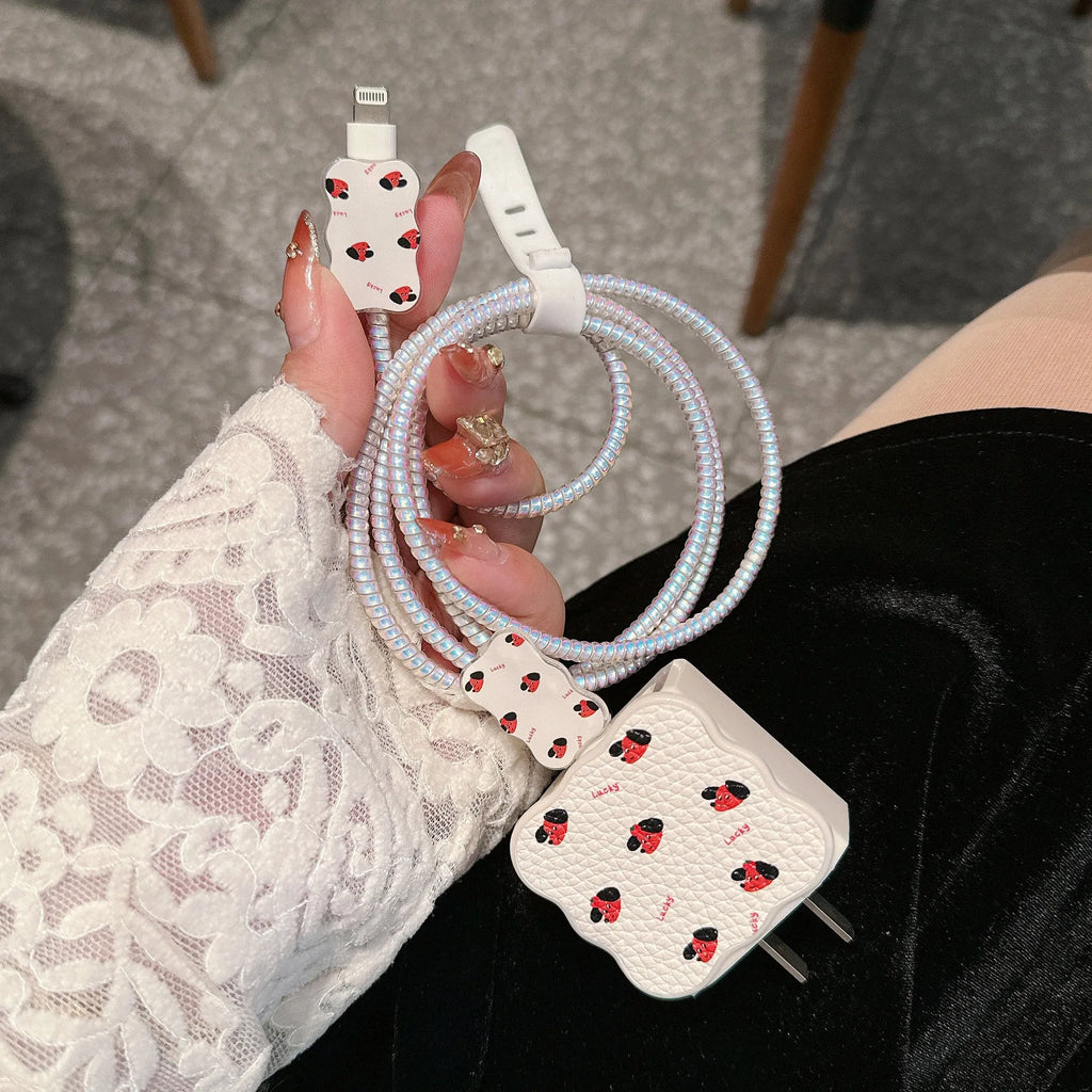 Set of four cartoon-design lambskin USB cable protection sleeves for 18W and 20W fast chargers.