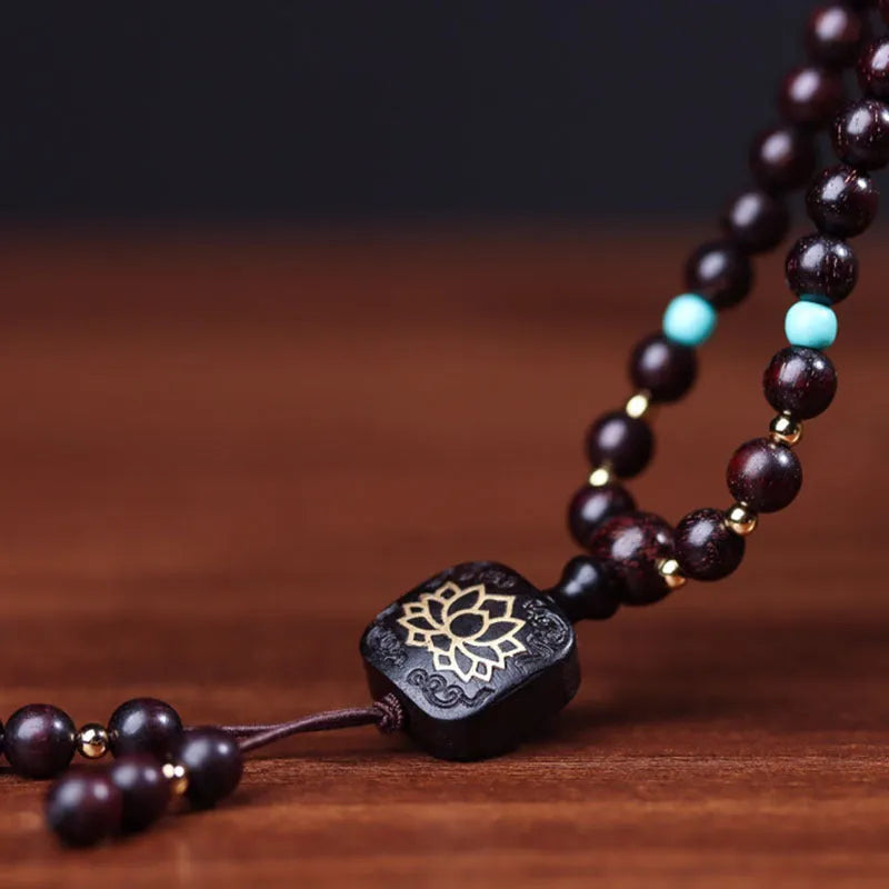 Zambian rosewood Buddha beads bracelet with flat lotus pendant showing 108 wooden beads
