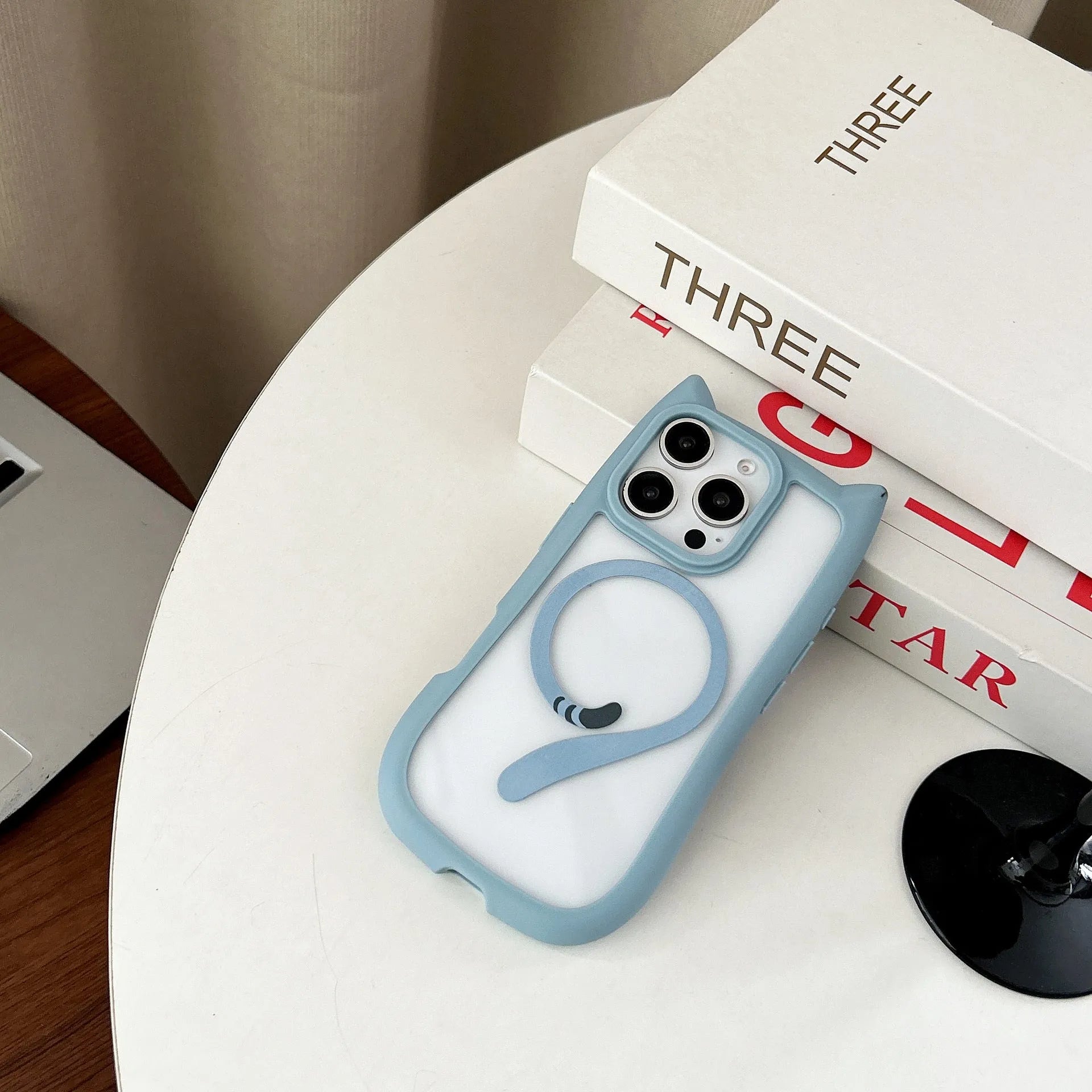 Transparent acrylic and TPU phone case for IPhone 17 with magnetic suction ring on back.