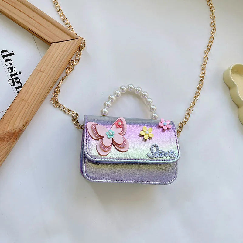 Children's small PU leather shoulder bag with letter print in rose red, showing zipper closure and multiple internal slots