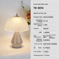 Geometric 3D table lamp in black with warm light on a wooden side table in a modern living room