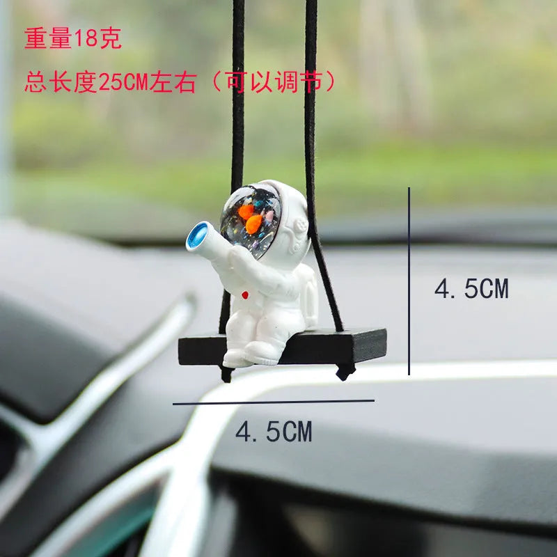 Resin cartoon astronaut car pendant decoration hanging from a rear-view mirror.