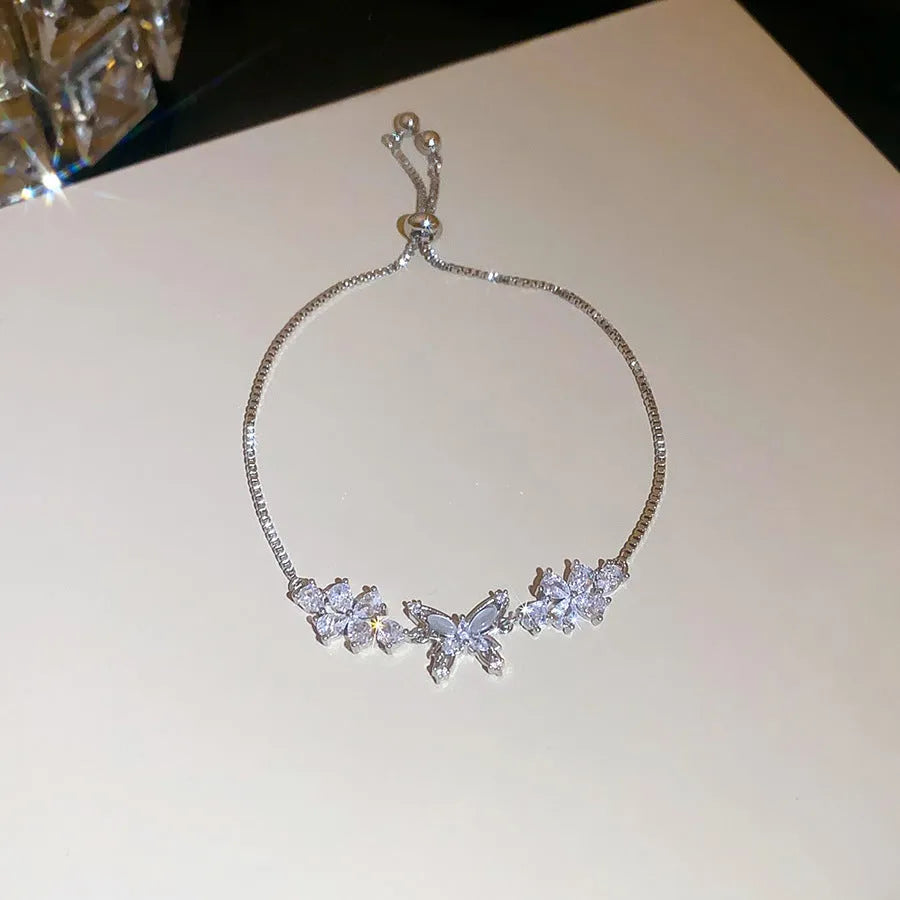 Flower butterfly pendant bracelet for women, copper inlaid zircon, gold finish on white background