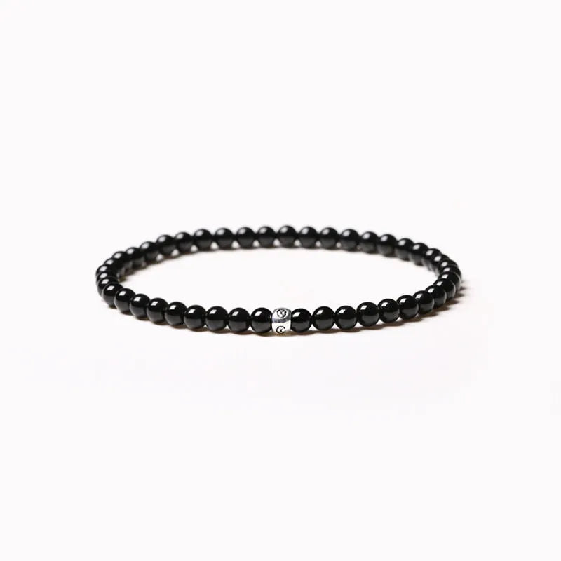 Geometric agate bracelet with obsidian, blue San, and black agate stones on wrist