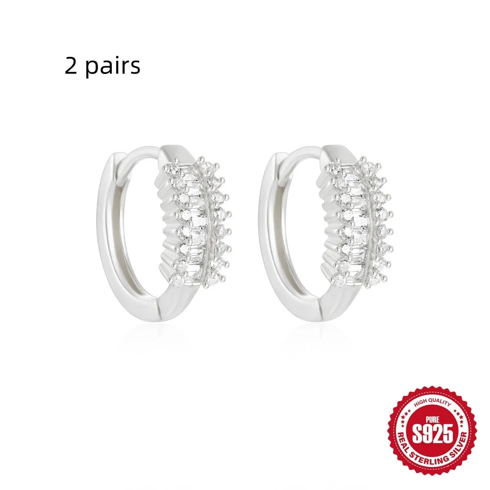 Sterling silver geometric stud earrings with round diamond accents in gold and silver electroplated finishes