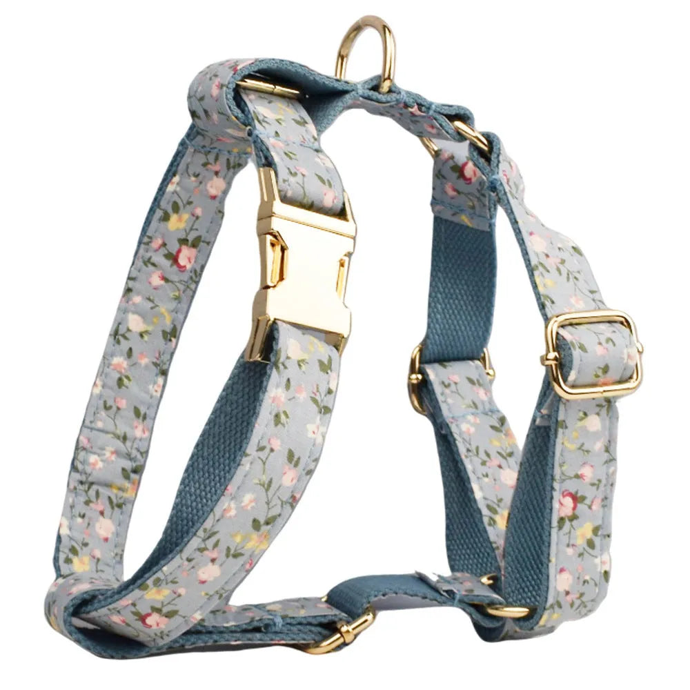 Blue floral patterned cloth dog collar and leash set with matching vest and bow accessories.