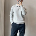 Men's grey striped knitted sweater with a lapel collar, shown in a loose fit.