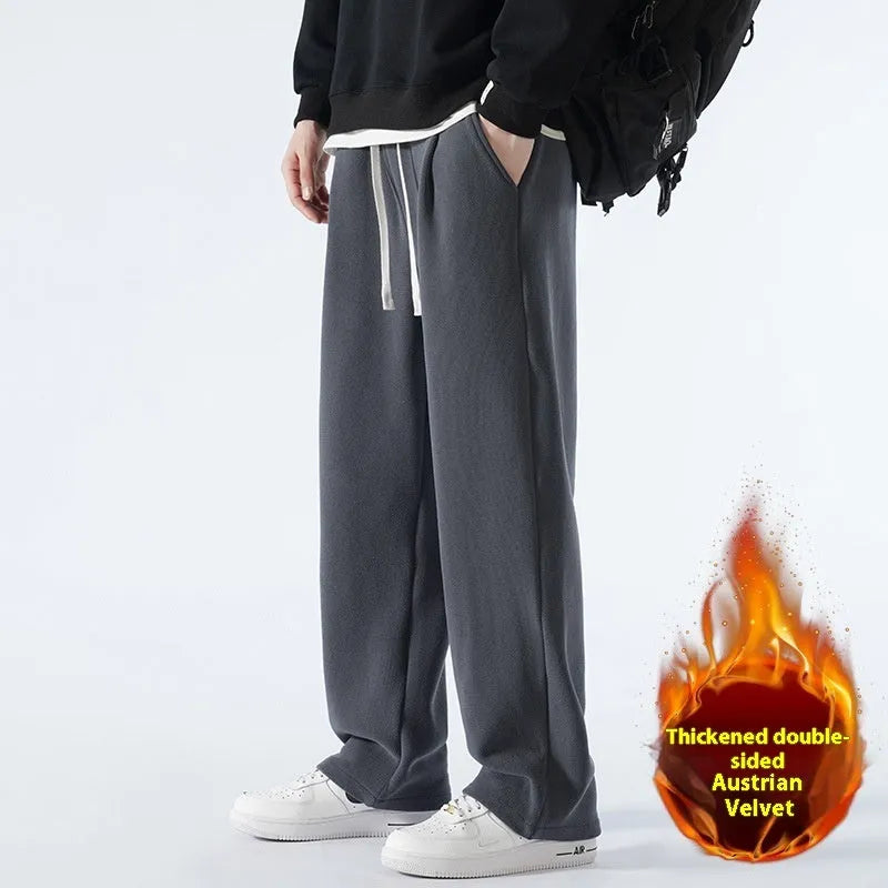 Men's double-sided polar fleece sports trousers in apricot, showing loose fit and drawstring waist.
