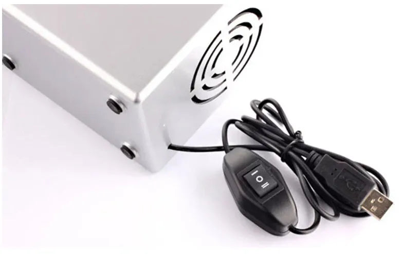Silver USB mini fridge with LED light, holding two cans, compact size for desk
