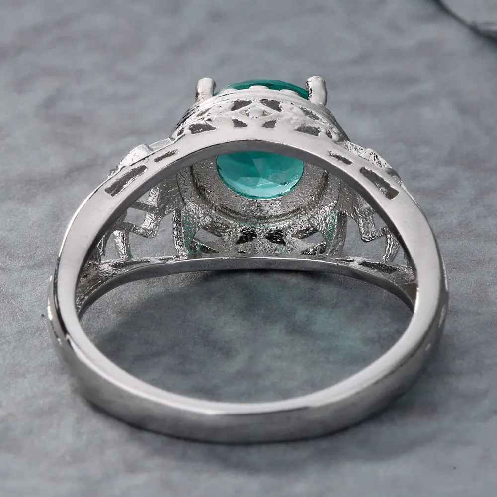 Silver electroplated copper ring with inlaid zircon stone on neutral background
