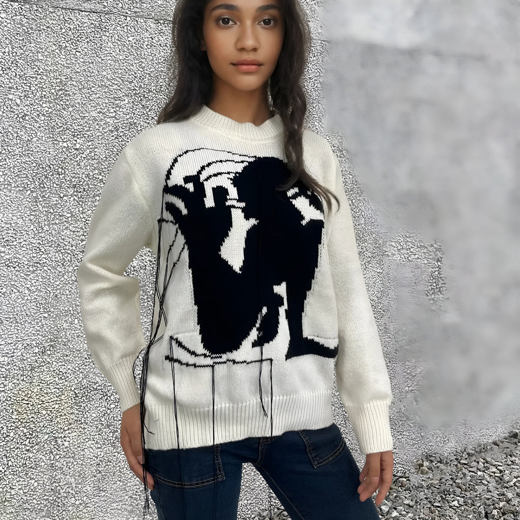 Women's grey alpaca wool sweater with tassel detailing and round neck.
