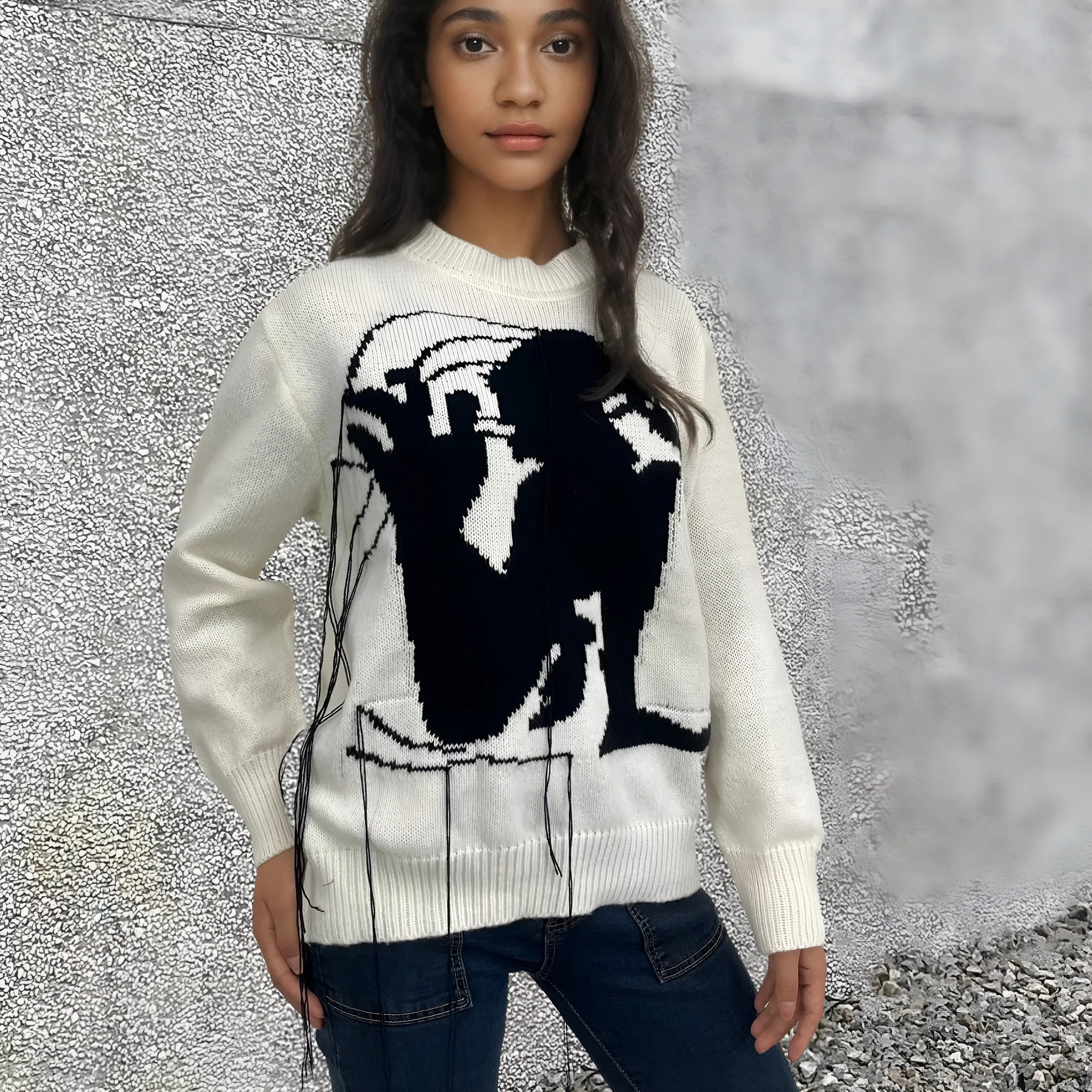 Women's grey alpaca wool sweater with tassel detailing and round neck.