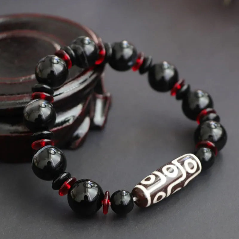 Black agate dzi bead bracelet with chalcedony stones in geometric design