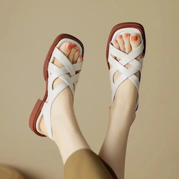 Women's glossy patent leather sandals with square toe and cross ankle strap in black, white, or brown.