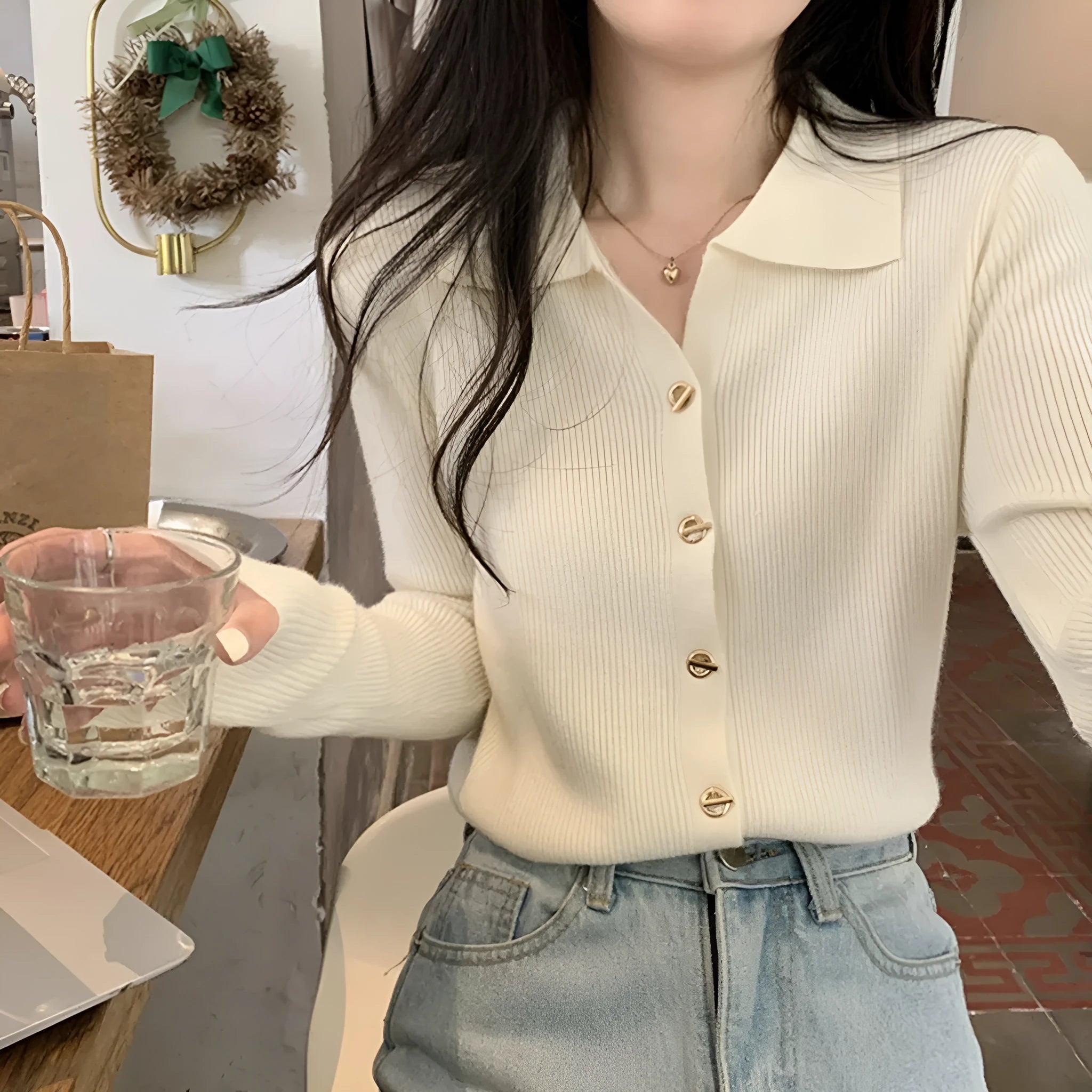 Loose fit knitted cardigan in beige, shown worn open as a long-sleeved top