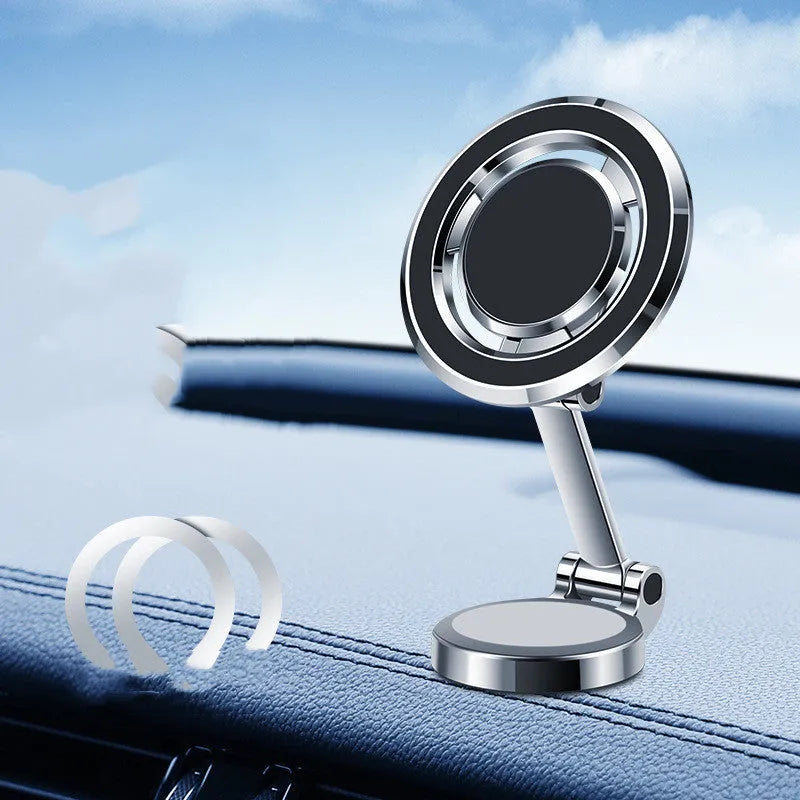 Black magnetic adhesive car phone holder with 360-degree adjustable bracket mounted on a dashboard.