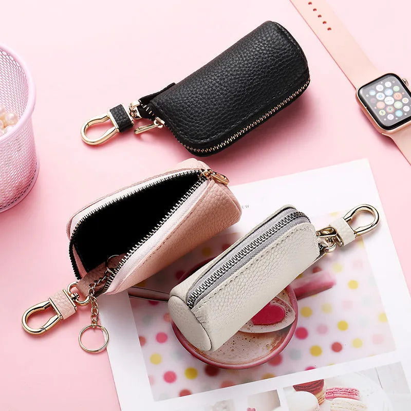 Men's fashion simple black PU leather zippered key ring case on a grey background.