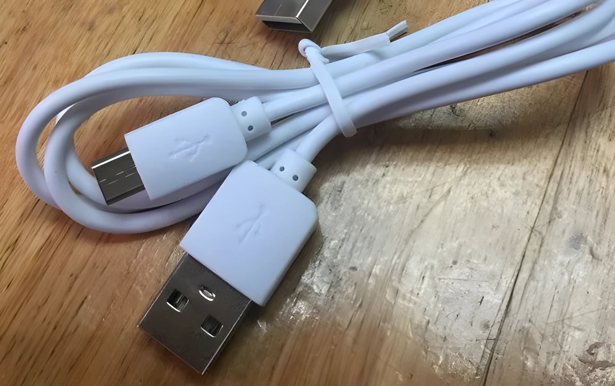White 1-metre micro 5-pin USB data and charging cable on a plain background