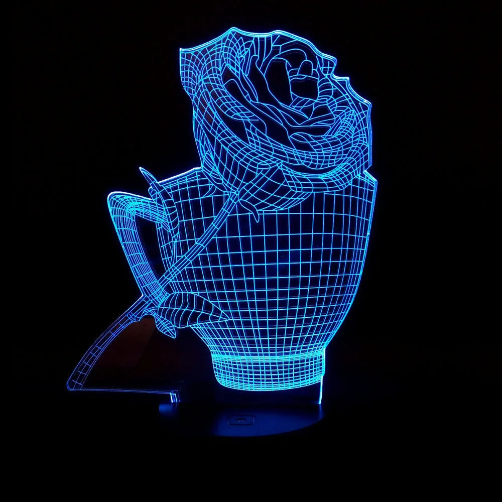 3D acrylic rose flower night light in black finish on a table, showing multicoloured LED illumination.