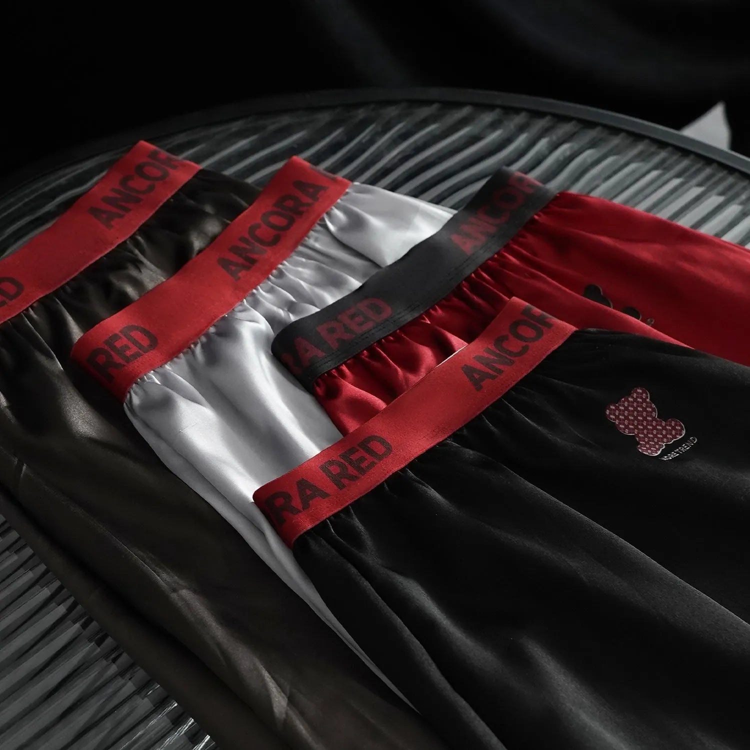 Men's solid colour boxer briefs showing mid-waist design and knitted polyester fabric in multiple colour options