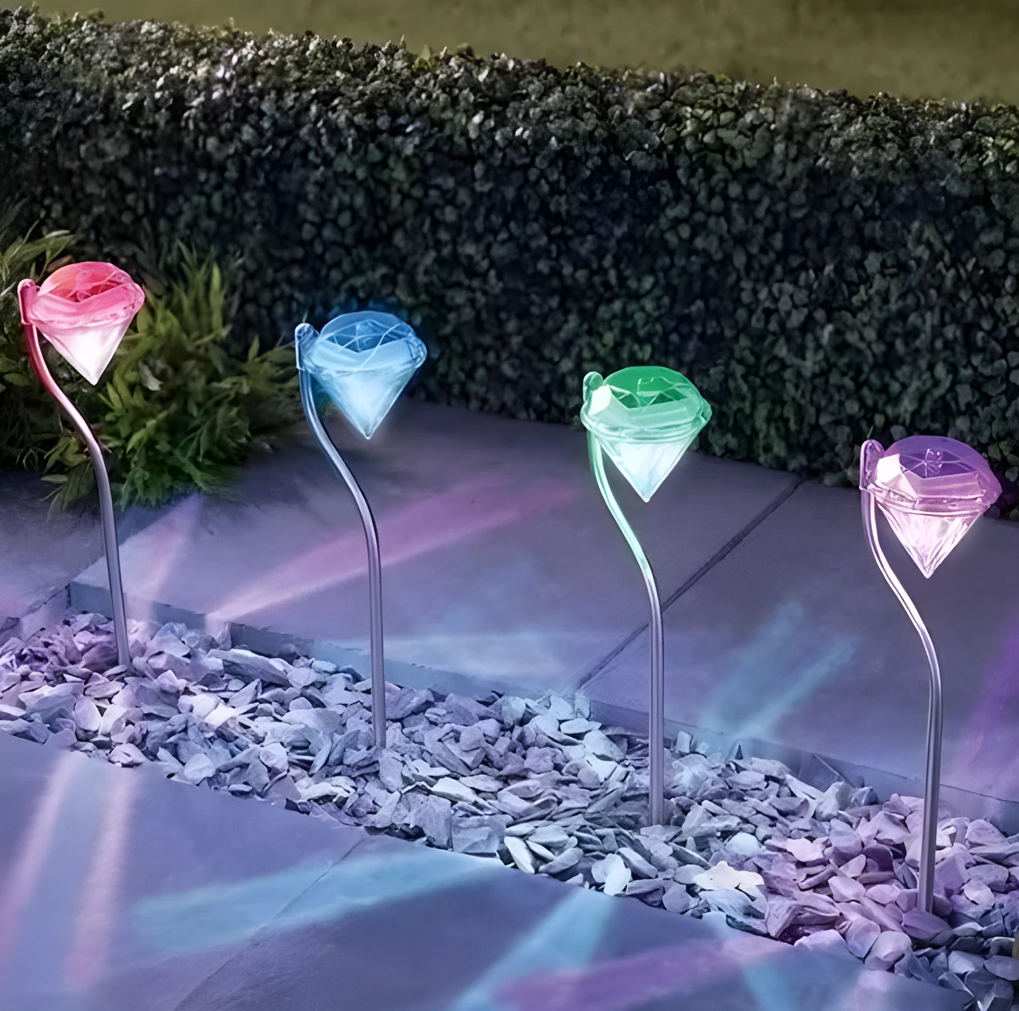 White solar-powered diamond-shaped garden spotlight with adjustable head on a stake.