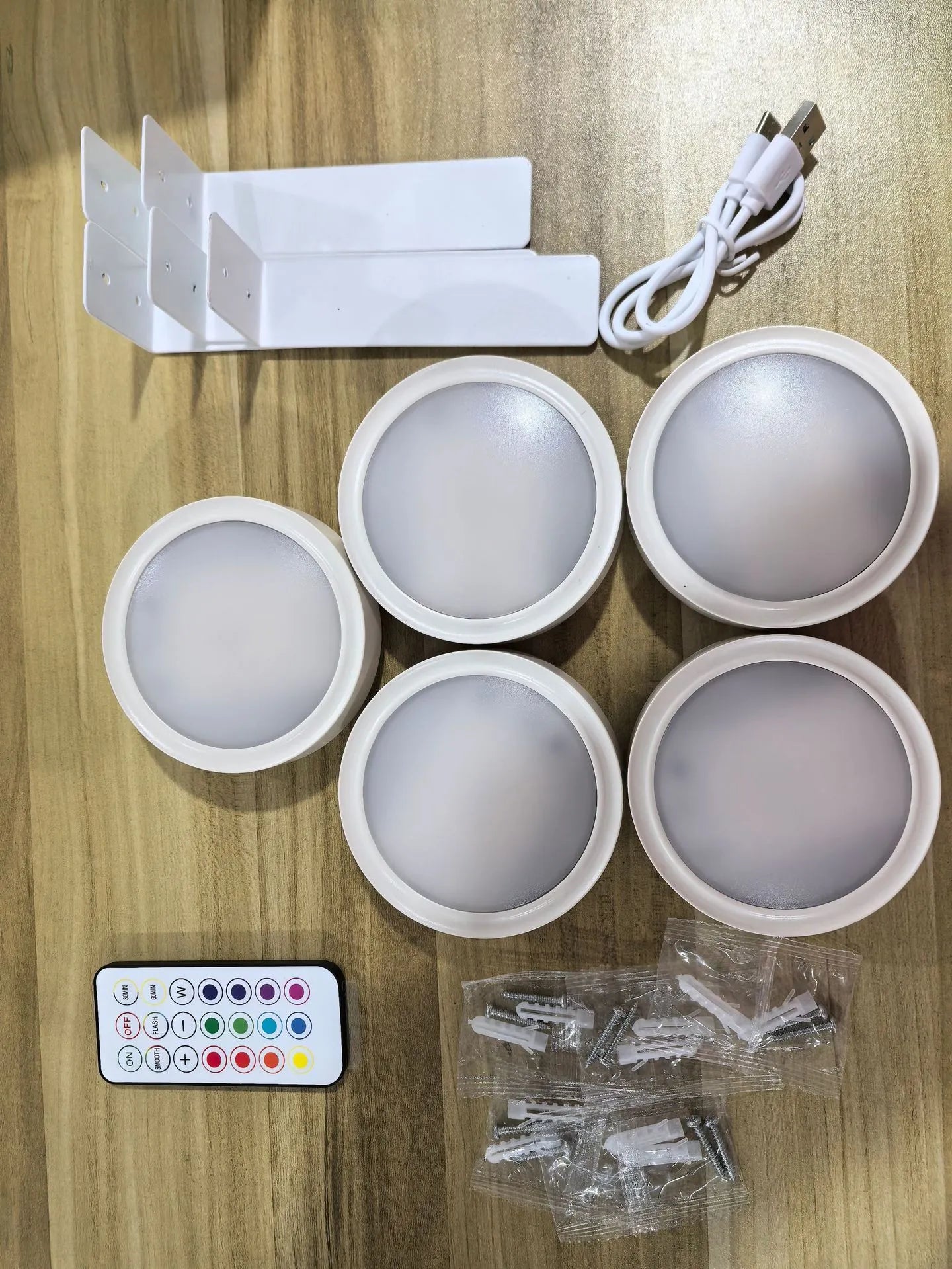 Wireless LED painting lamp with a magnetic mounting belt and remote control in black finish.