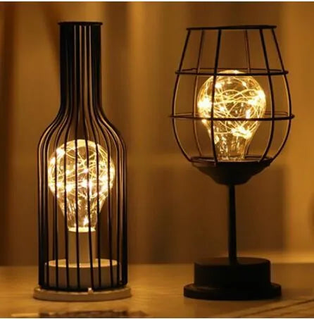 Minimalist hollow iron table lamp in wine glass or bottle design with warm white LED light
