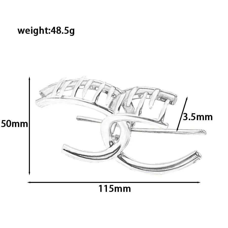 Assorted silver metal hair claws and barrettes including wave, knot, bow, and pearl designs on a white background.