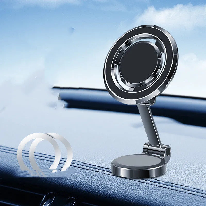 Black magnetic adhesive car phone holder with 360-degree adjustable bracket mounted on a dashboard.