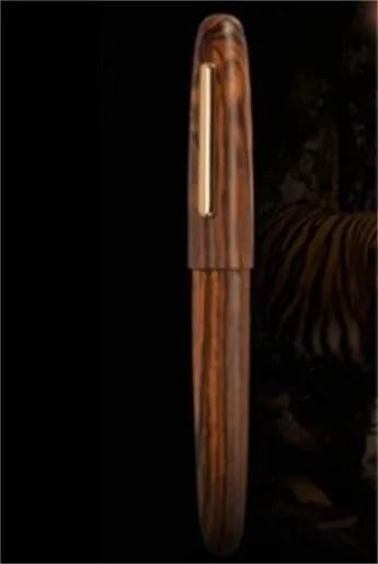 Wooden fountain pen with rotating cap shown in various wood finishes including rosewood and ebony.