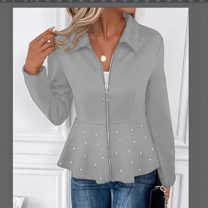 Women's loose fit black coat with a beaded zipper and ruffled hem detail on mannequin.