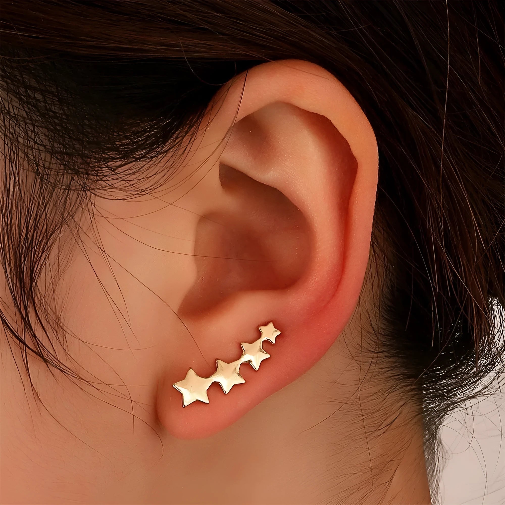 A pair of copper KC Golden Star leaves design clip-on earrings for women.