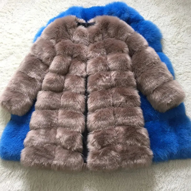 Women's long artificial fur coat in wine red colour on a hanger