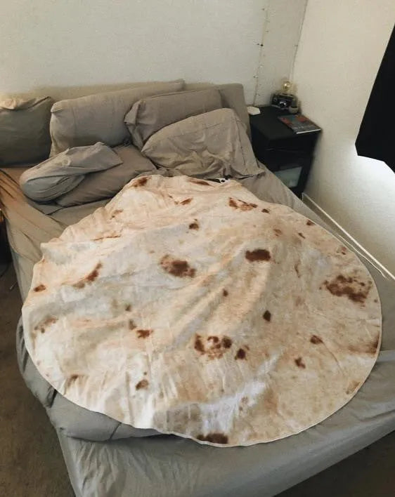 Round burrito design blanket in coral fleece flannel with tortilla print, folded to show size