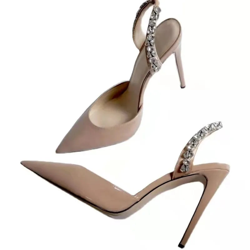 Women's patent leather high heel sandals with pointed toe, clear ankle strap, and rhinestone details.