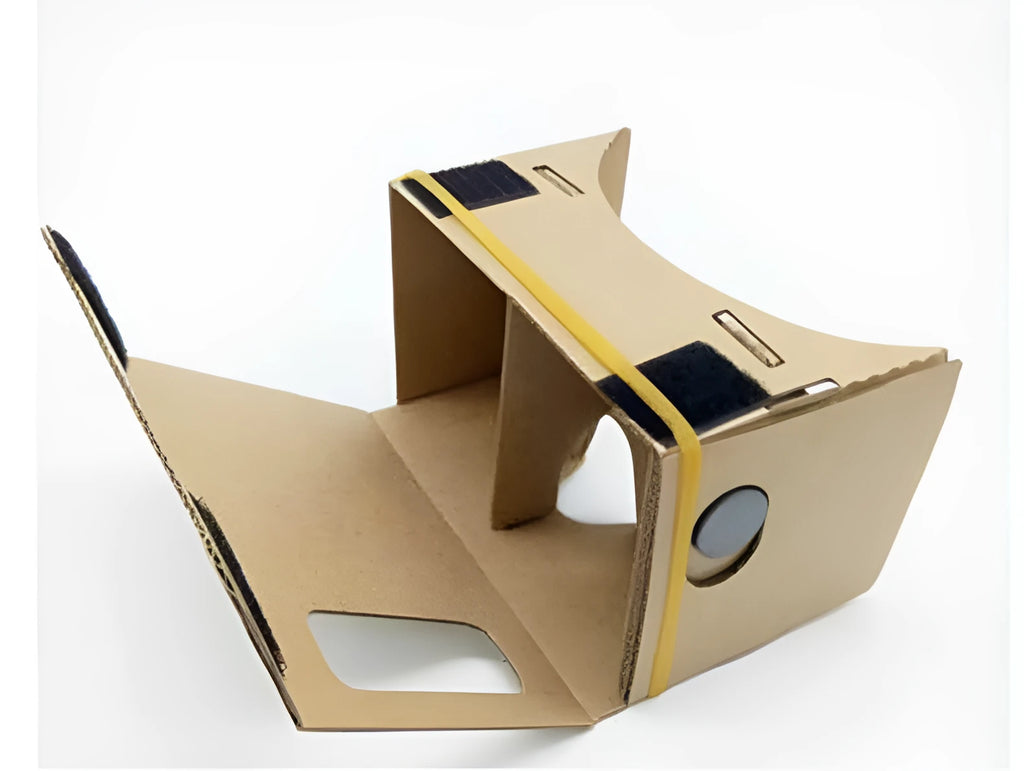 Pink and white cardboard VR glasses for smartphones, shown with 3D lenses and a rubber headband.