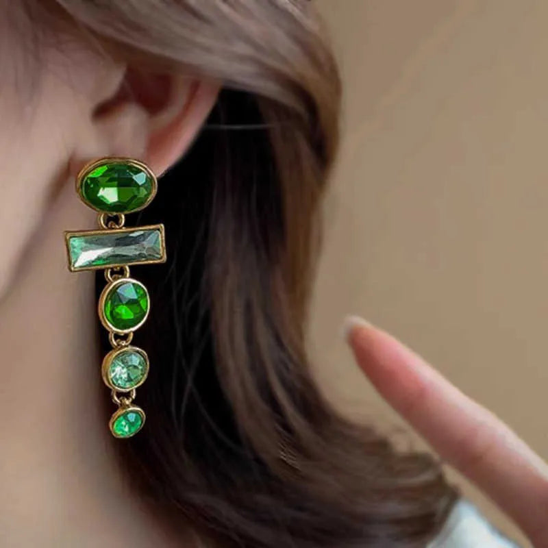 A pair of geometric Chinese style alloy earrings with a retro green gradient finish and zircon-inlaid tassels.