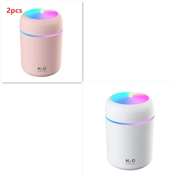 Pink USB desktop humidifier with colourful LED lights and 300ml water tank on wooden desk