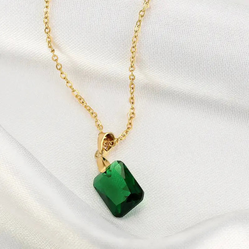 Copper geometric necklace with rectangular green pendant on an O-ring chain.