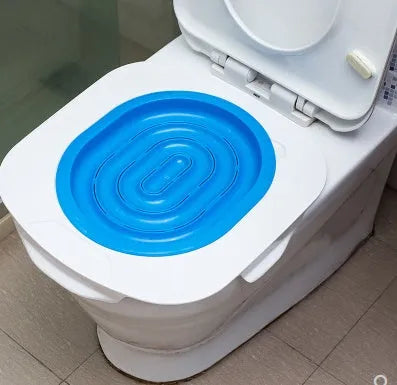 Blue cat toilet trainer with grooved removable trays placed on a white toilet seat