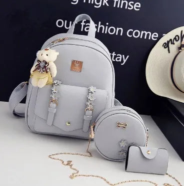 Women's 3-piece floral leather bag set showing backpack, shoulder bag, and card purse