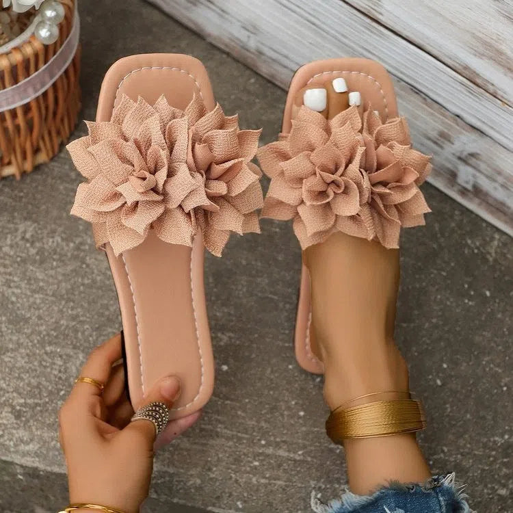Flat flip-flops with flower decoration in faux leather and rubber sole in black colour for women